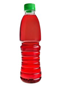 Plastic bottle with red juice isolated over white background.